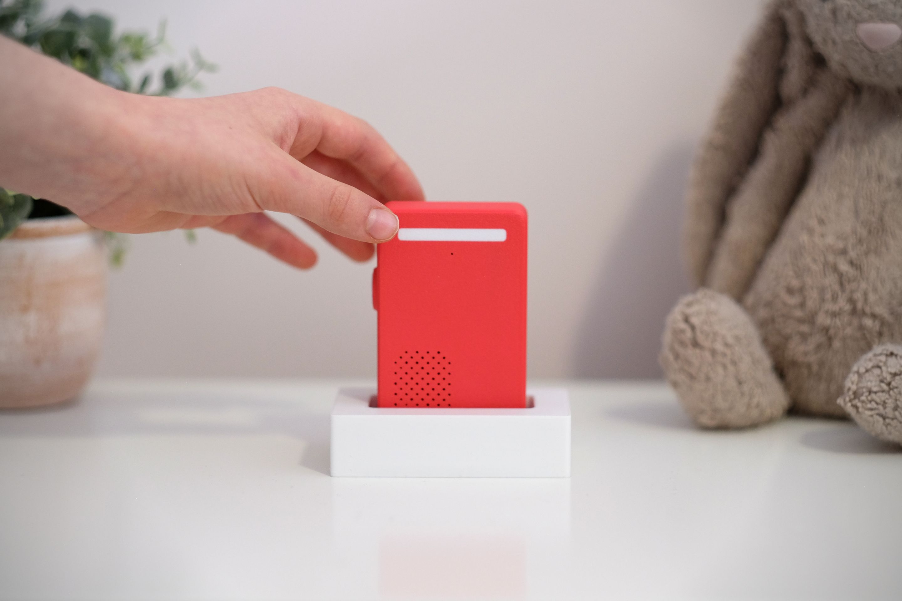 Hand placing Poppy into its dock